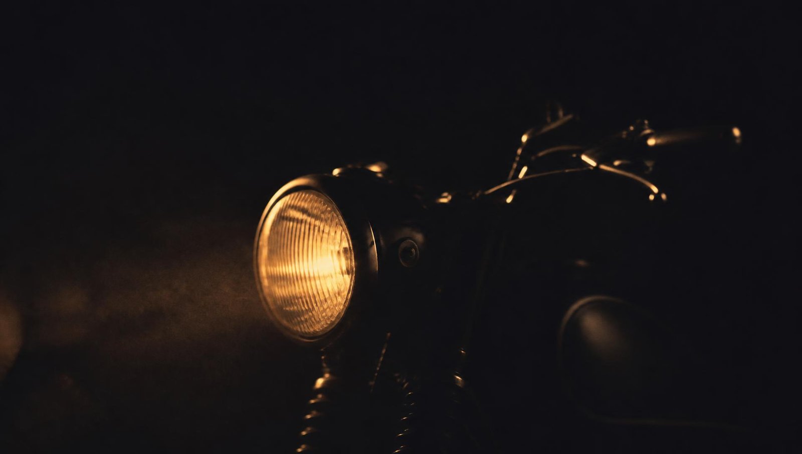 A single headlamp cutting through the dark